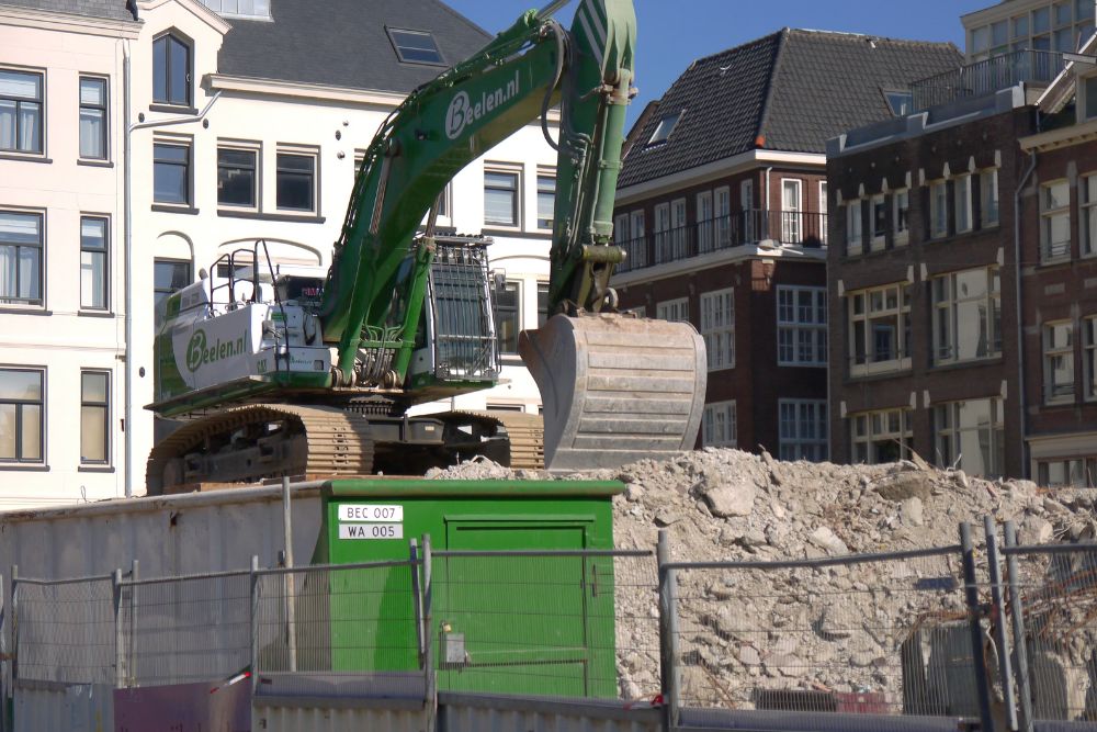 A green and black construction machine, symbolizing construction and renovation services in Sacramento, California.