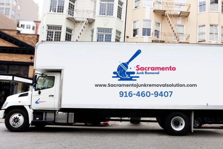 A moving truck is stationed outside a building, indicating a junk removal service in Sacramento, California.